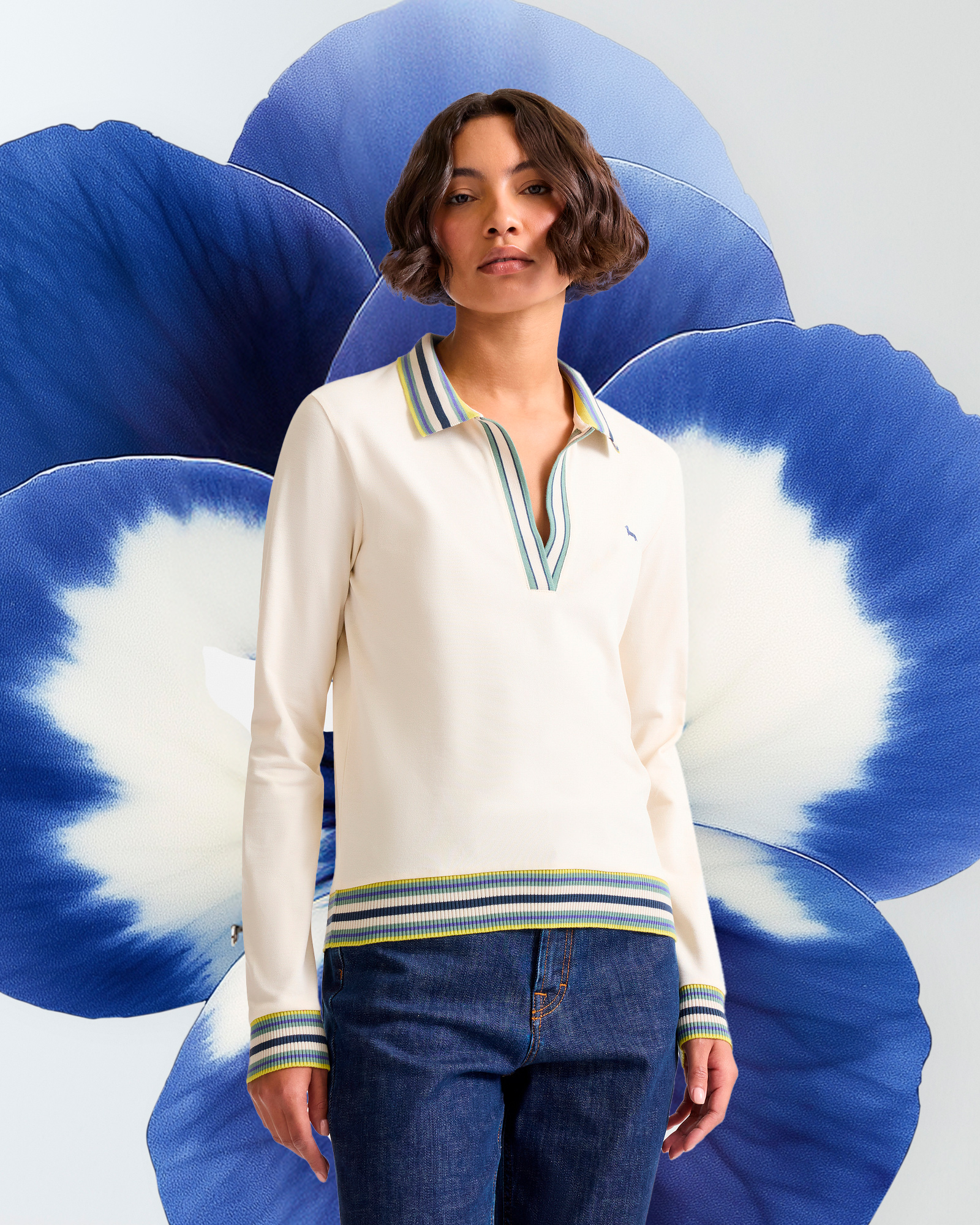 Woman wearing light blue V-neck polo shirt with striped details