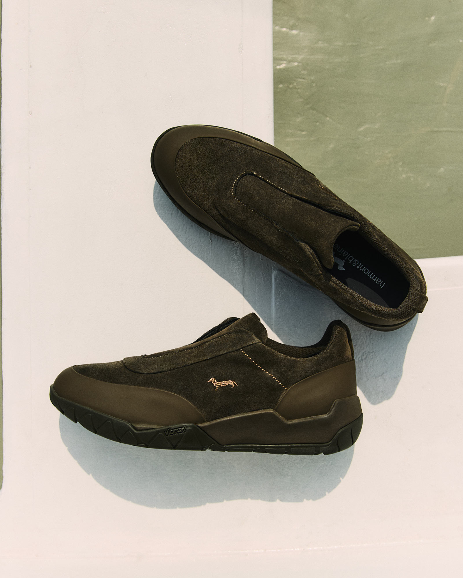 Camicia a quadri in primo piano, sfondo grafico floreale.