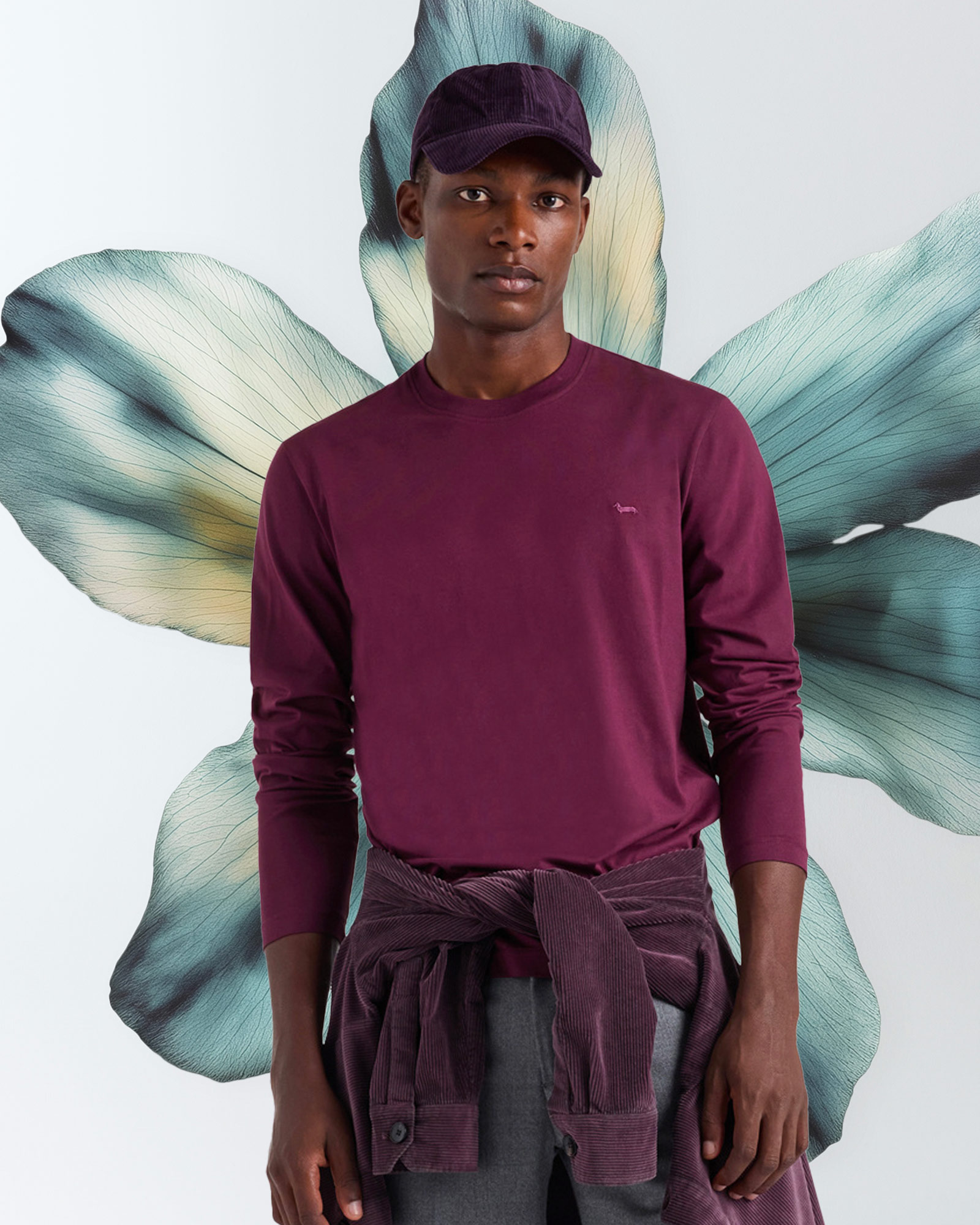 Man wearing burgundy sweatshirt and matching cap