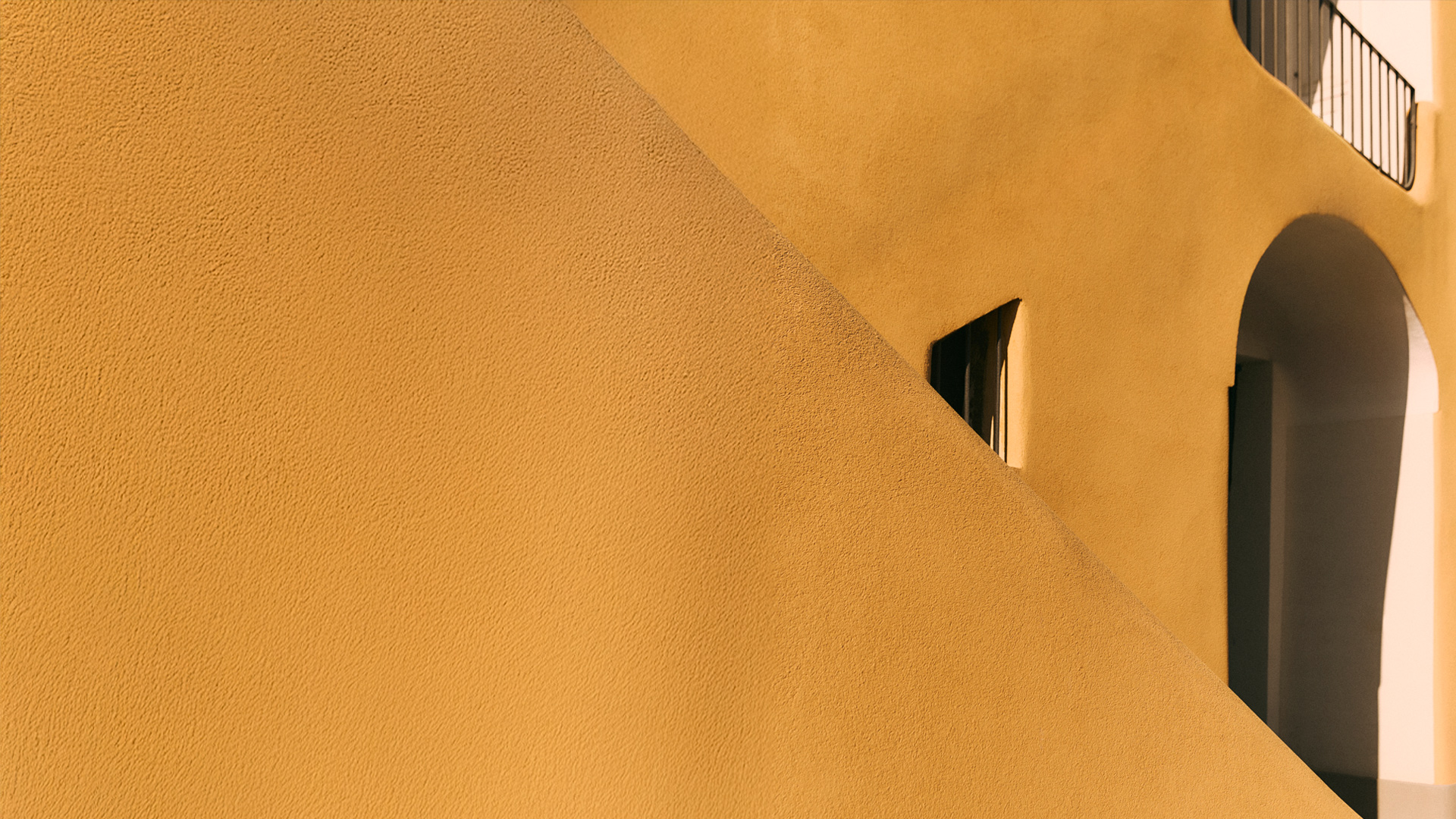 Yellow wall with arch and shadows