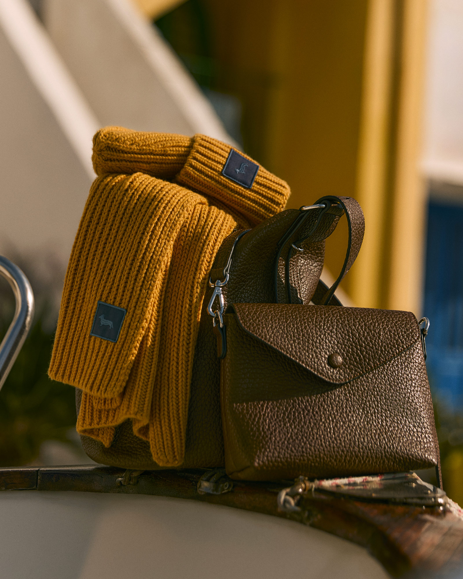 Men's accessories with mustard scarf and beanie and brown crossbody bag