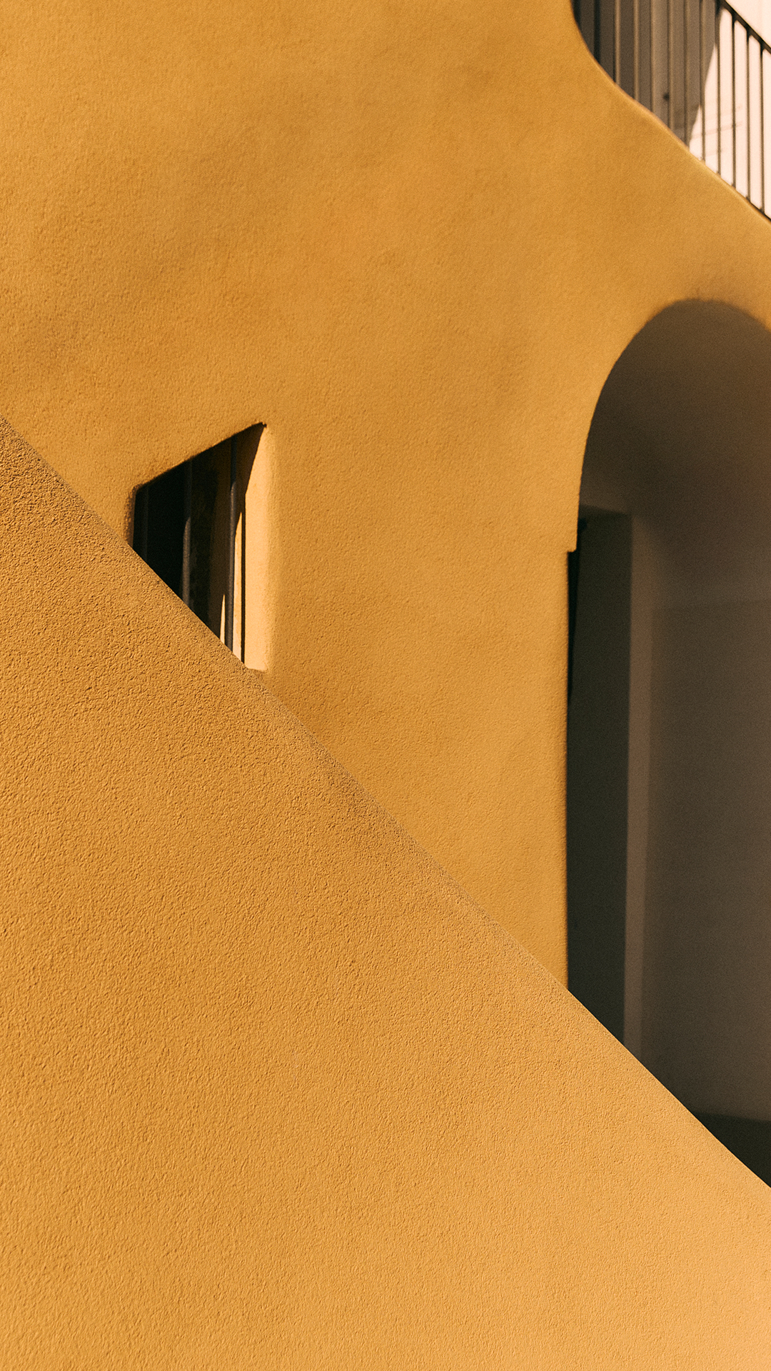 Yellow wall with arch and shadows