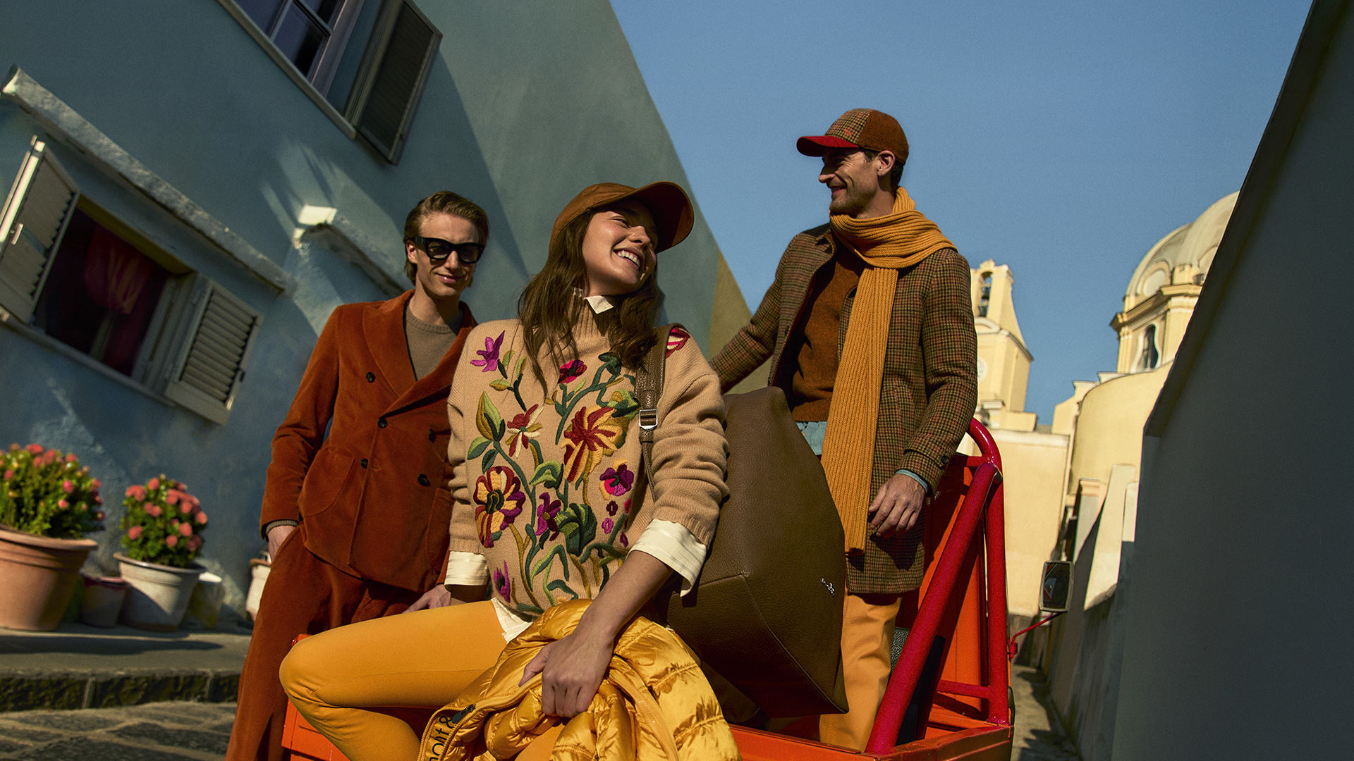 Group of friends in colorful autumn outfits outdoors.