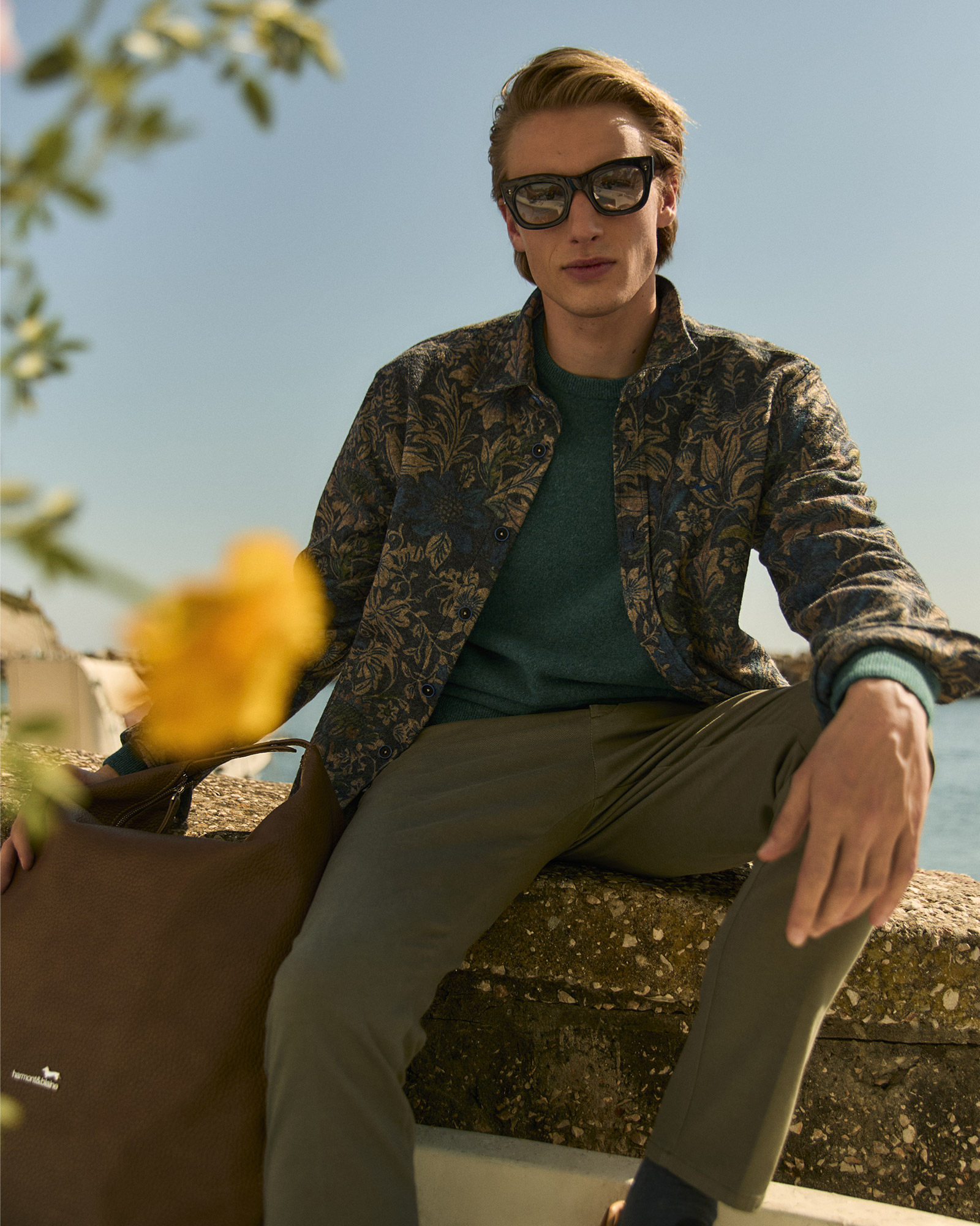 Man con camicia fantasia e pantaloni verdi