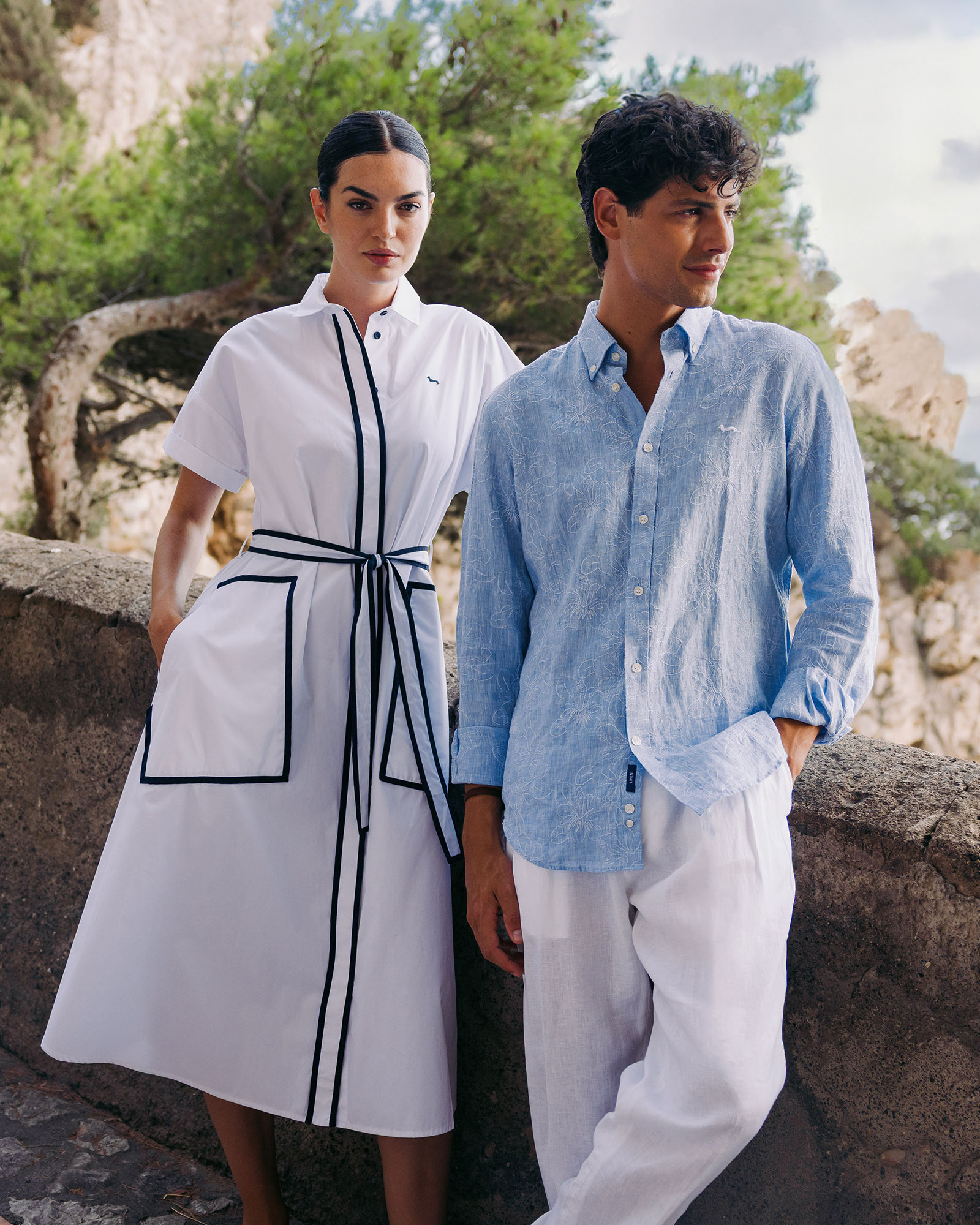 Stylish couple in summer outfits on a scenic terrace