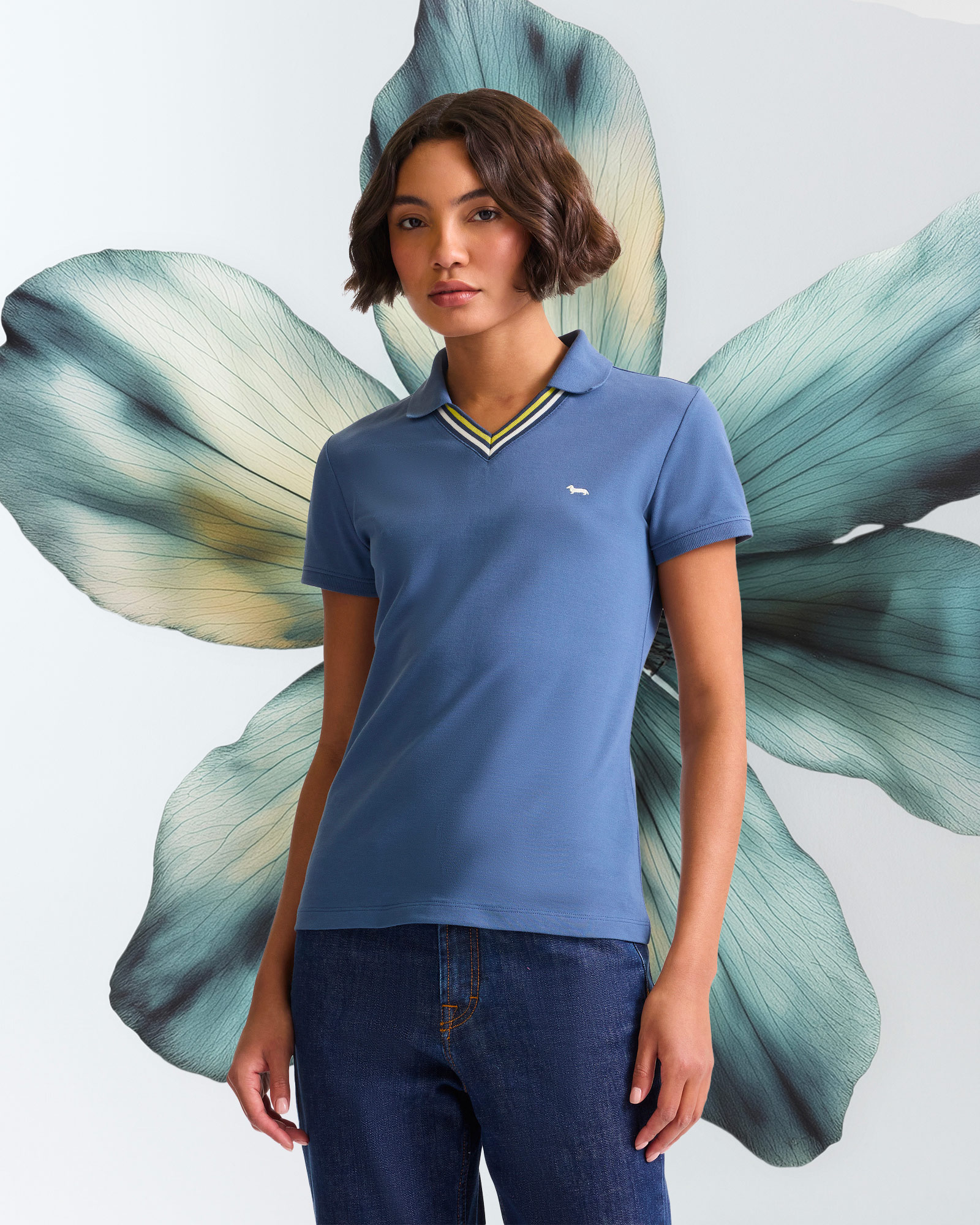Woman wearing light blue V-neck polo shirt with striped details