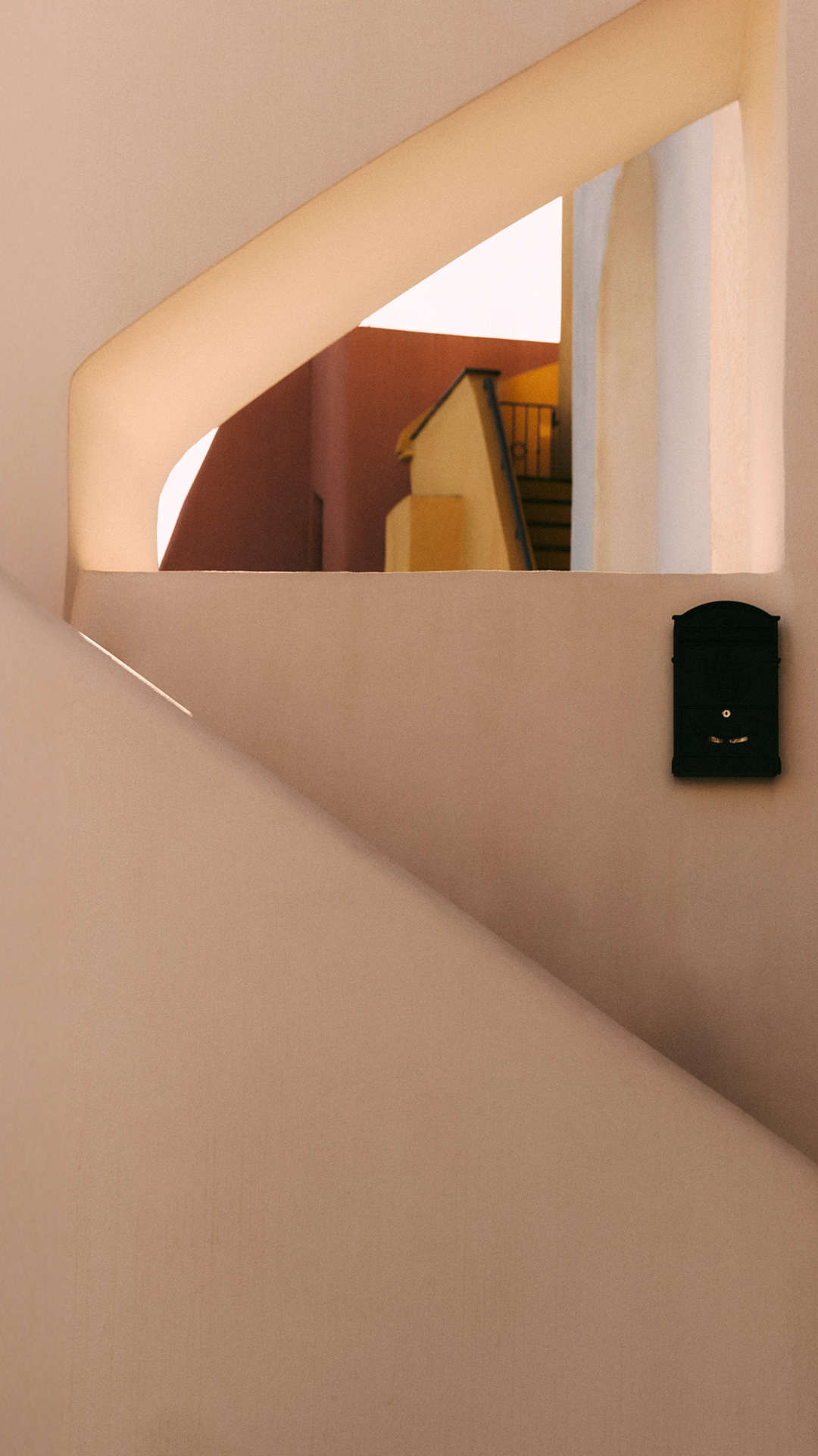 Architektonisches Detail eines Gebäudes mit cremefarbenen und ockerfarbenen Wänden.