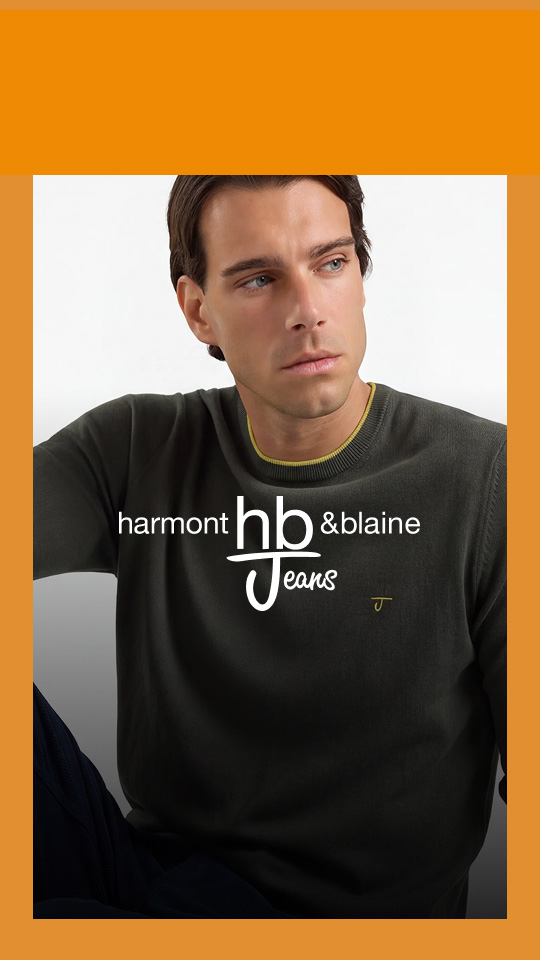 L'immagine rappresenta il banner promozionale per la promo HallowEEK HB Jeans. Mostra un modello maschile seduto su sfondo chiaro con maglia verde oliva e pantaloni scuri, incorniciato da un bordo arancione e sovrastato in posizione centrale dal logo bianco "Harmont & Blaine HB Jeans