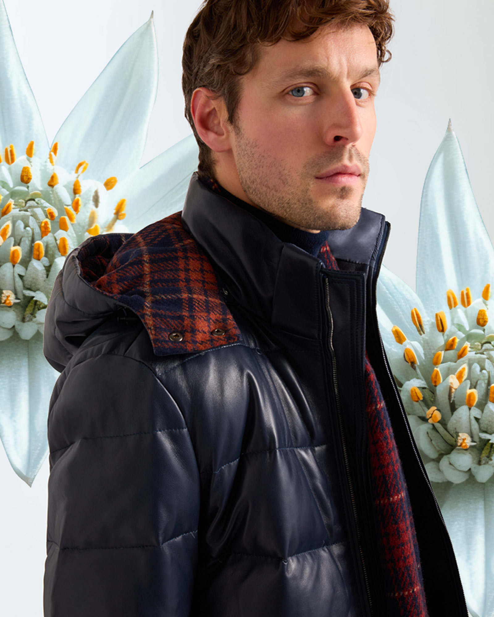 Man wearing navy puffer jacket and blue-red checked shirt.