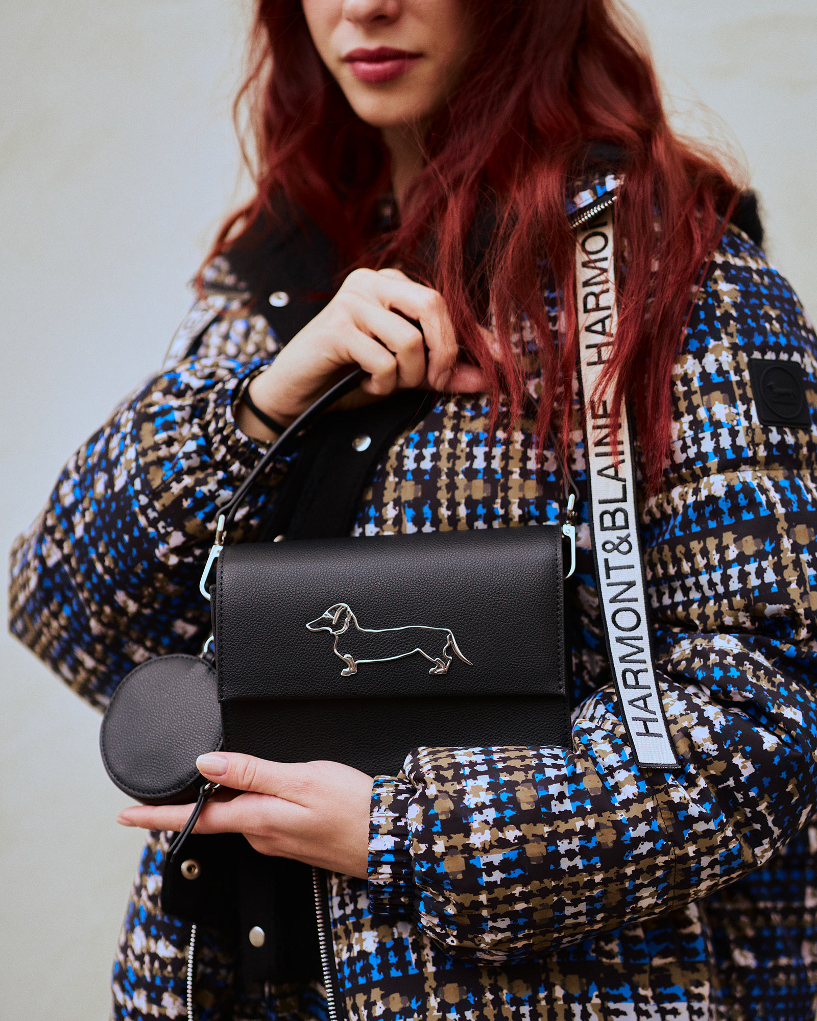 Fashion accessories on table, ochre wall behind.