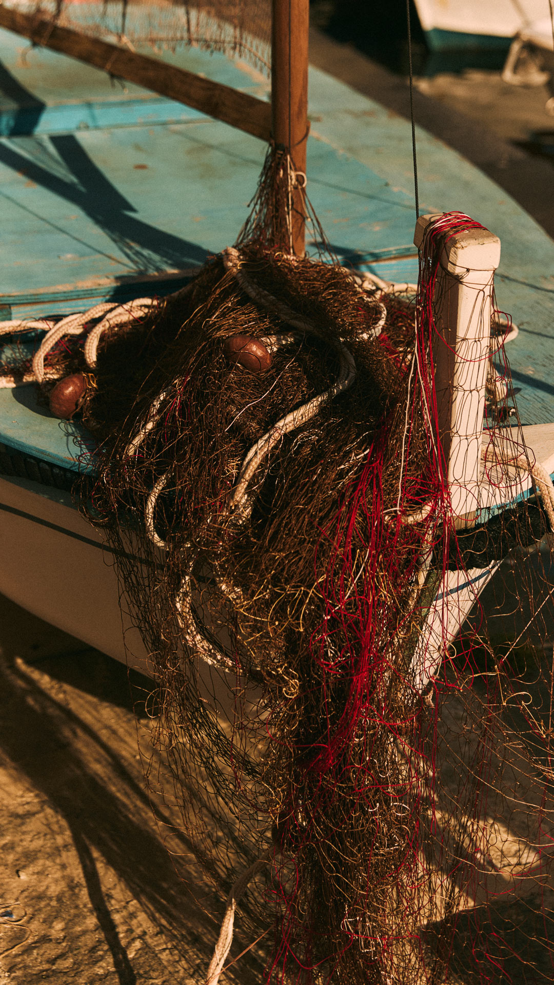 Fishing boat with tangled fishing net on deck.