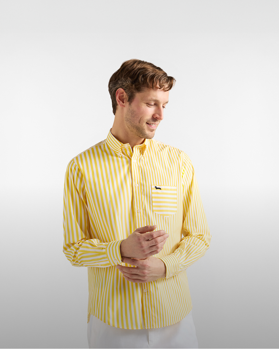 Donna con giacca a vento beige e camicia a righe con cappellino rosa