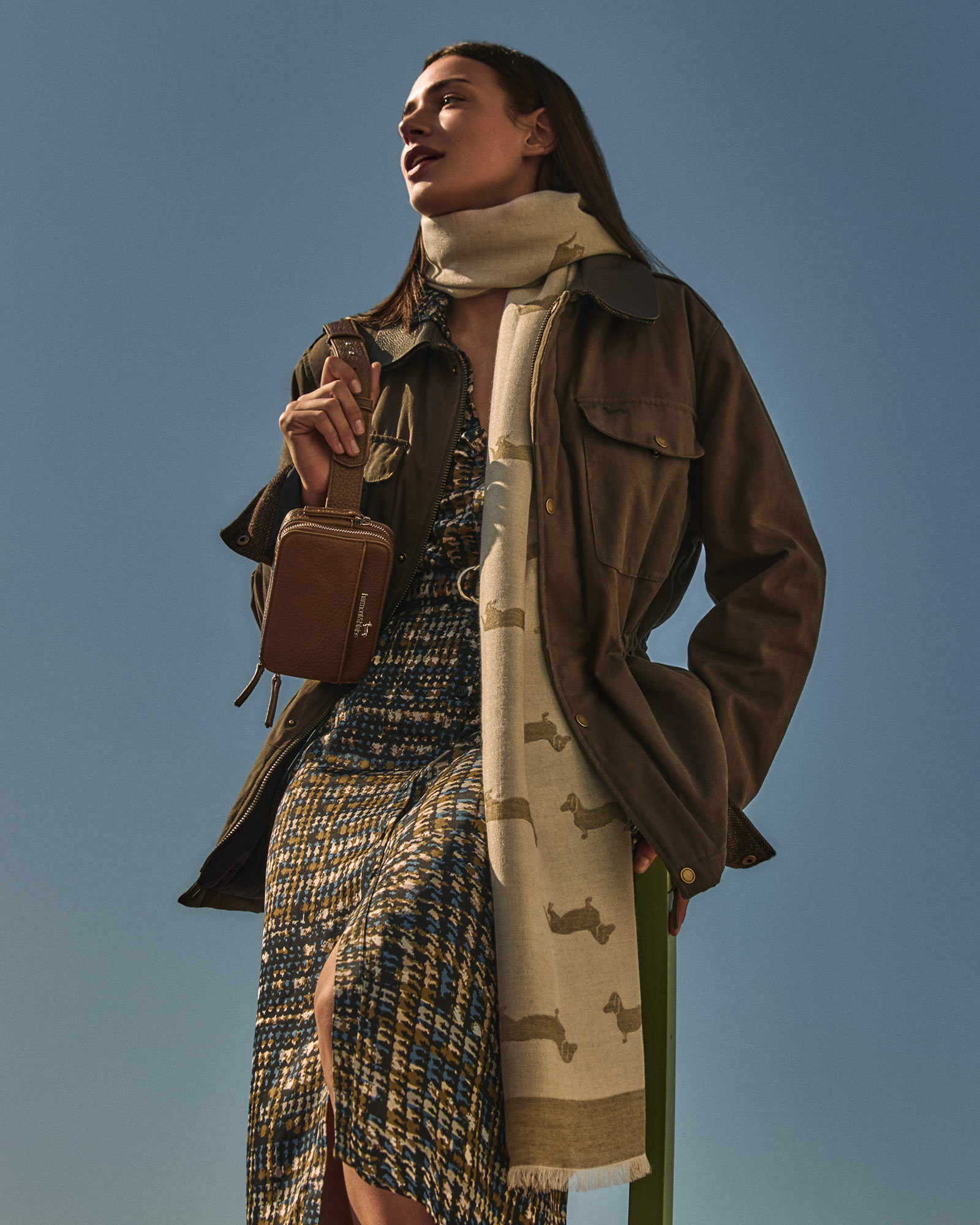 Person in winter dress against light decorative background.