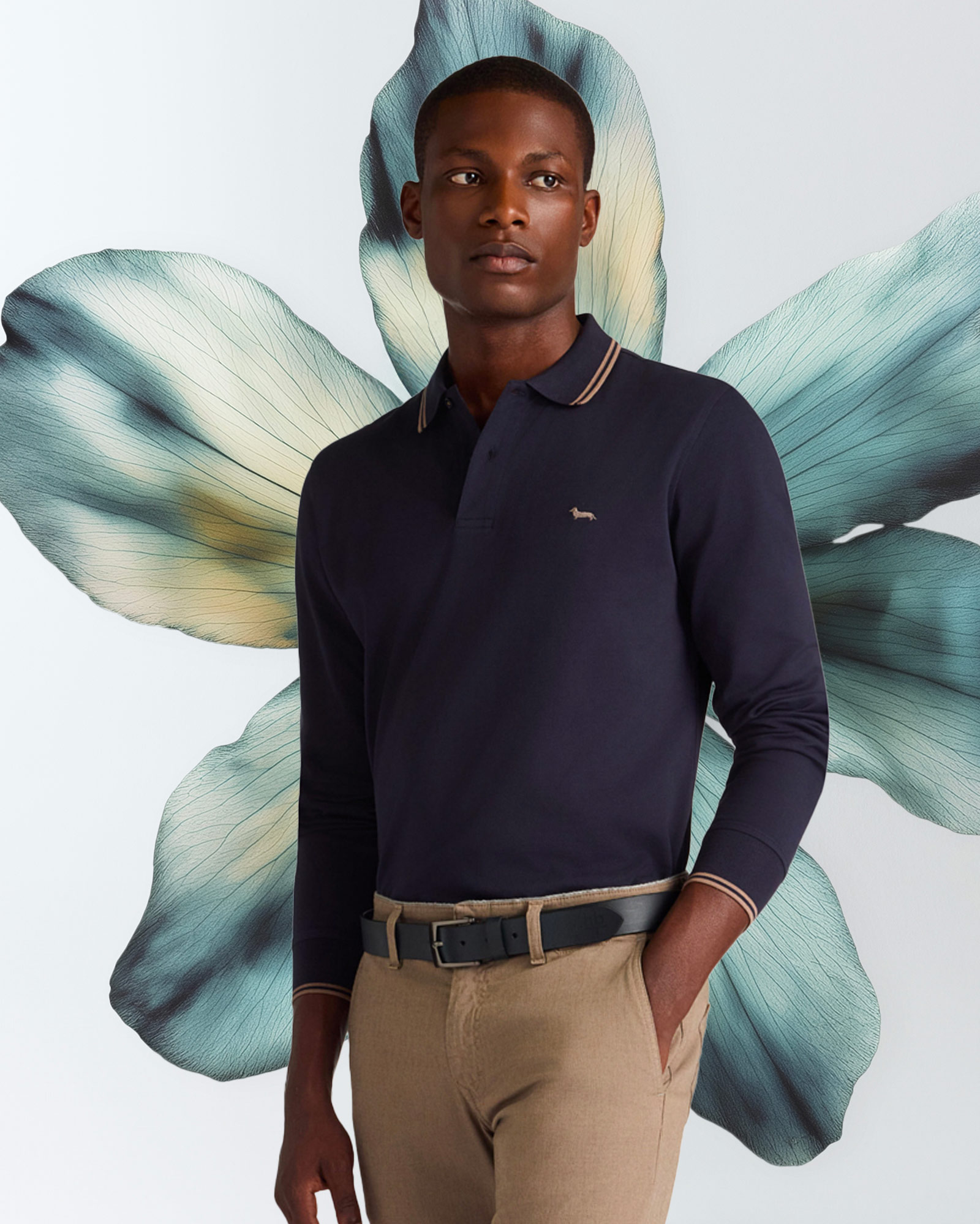 Man wearing navy blue long-sleeve polo shirt and beige trousers