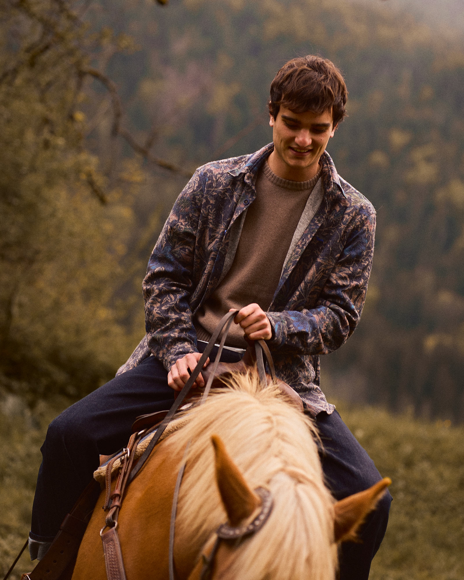 Person indoors wearing a checked shirt, neutral background
