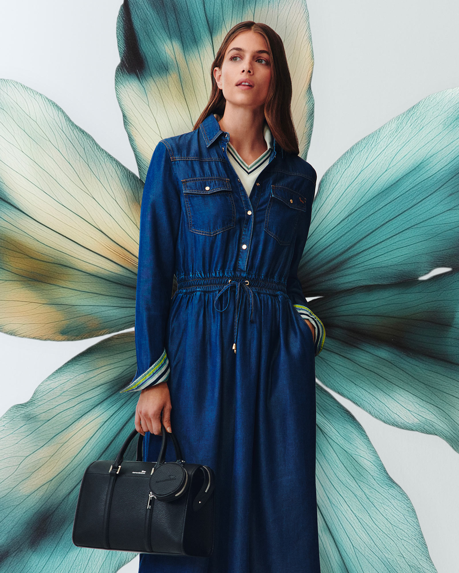 Person indoors wearing a light dress, neutral background