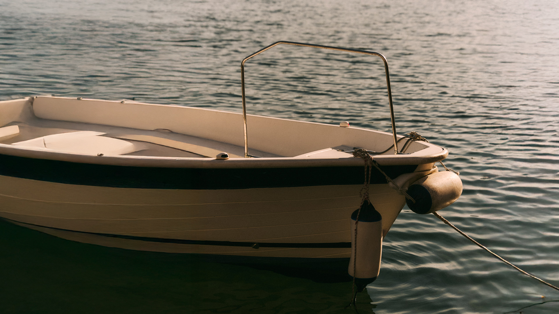 Bow detail of a boat moored on the water.