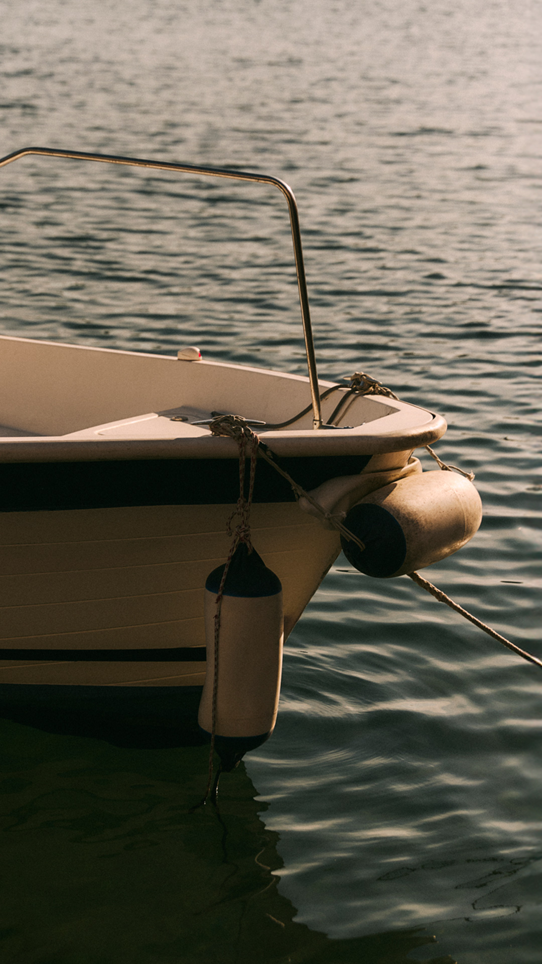 Bow detail of a boat moored on the water.
